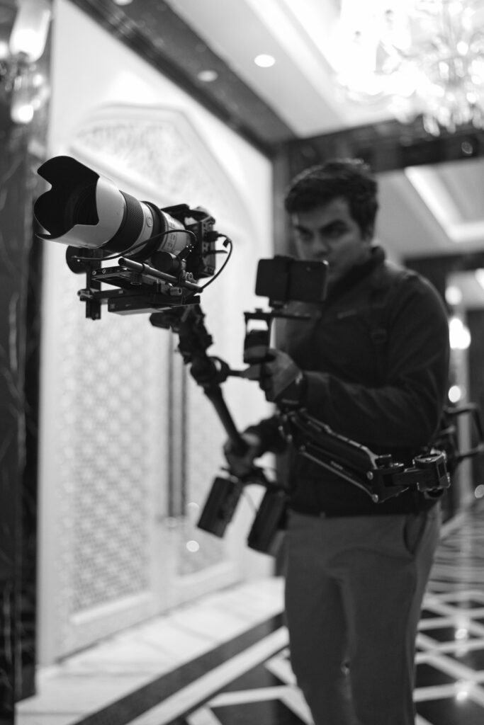 Steadicam operator framing a shot with the rig in a hotel lobby