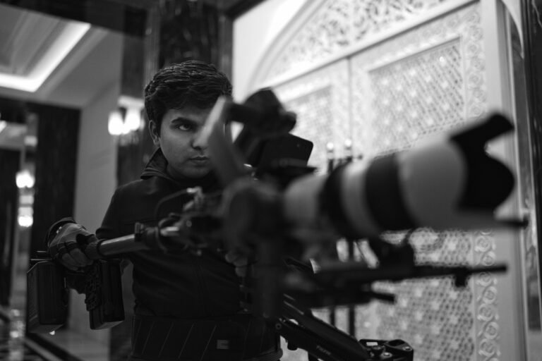 Camera operator with a telephoto lens on set at an Illusionary Realm shoot